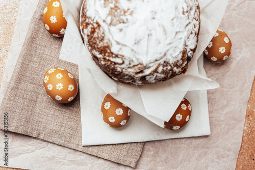 Obraz na płótnie Traditional Easter cake with hand-painted daisy eggs on fabric. Homemade festive baked goods and decor... w salonie
