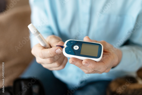 Patient testing blood glucose level using glucometer at home