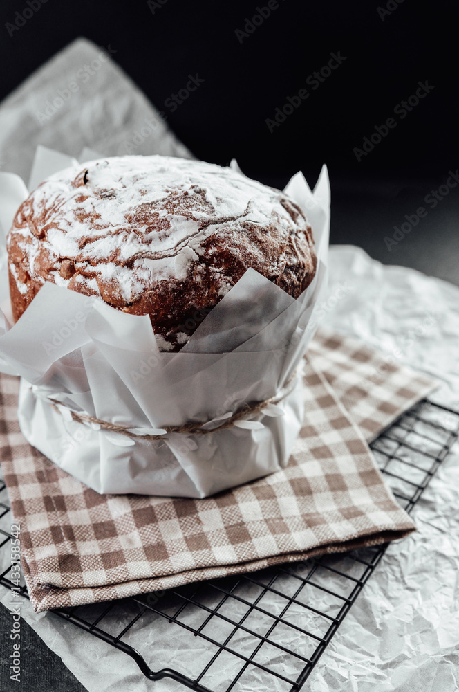 Easter sweet bread with sugar crust in baking paper. Festive baked dessert for spring celebration