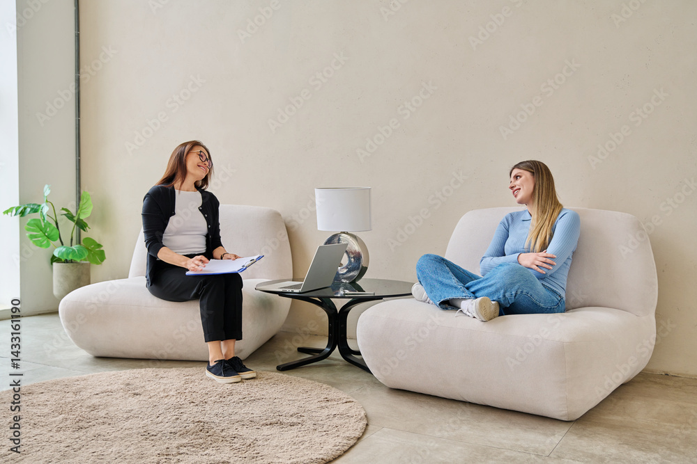 Young smiling woman in mental therapy talking with professional psychologist