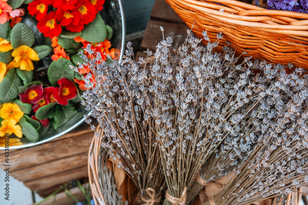 Lavender and colorful flowers arranged in baskets at a market during spring