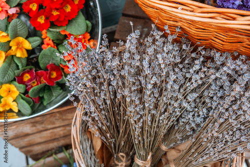 Obraz na płótnie Lavender and colorful flowers arranged in baskets at a market during spring w salonie