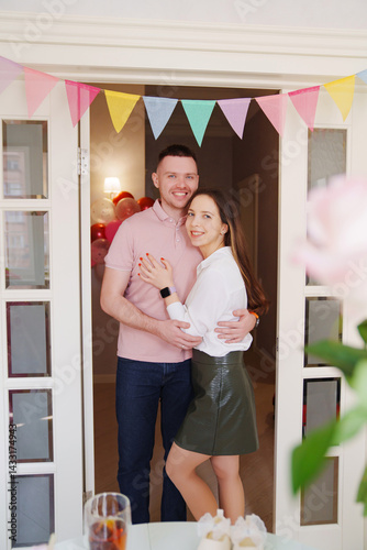Happy married couple hugging in the doorway in the apartment. housewarming