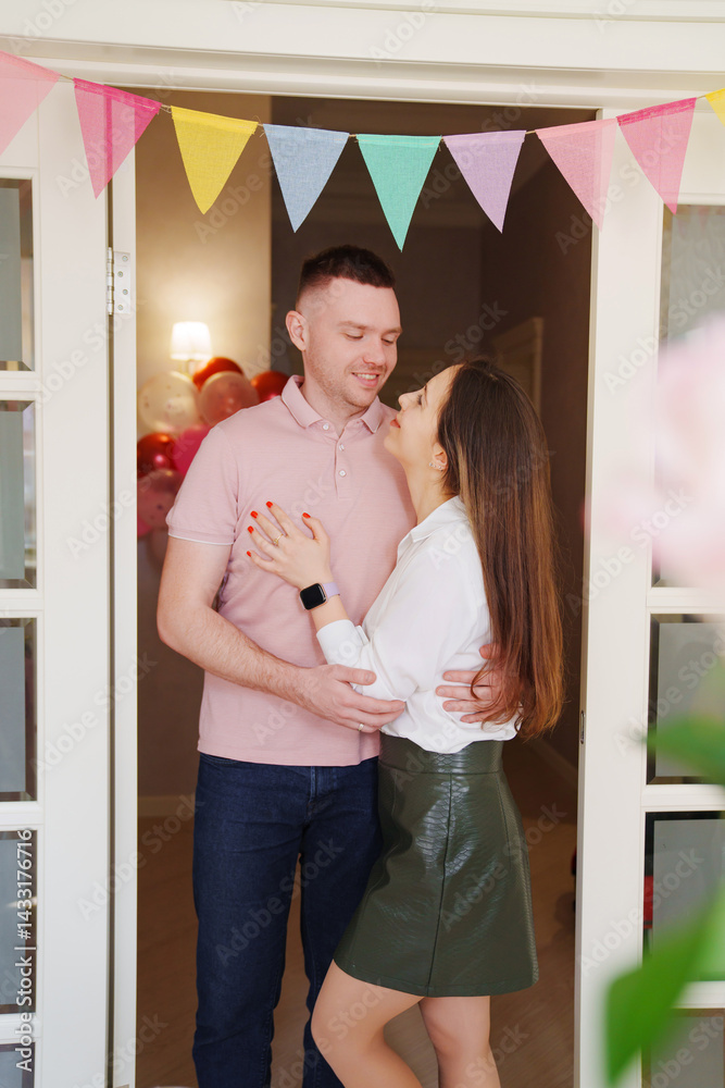 Happy married couple hugging in the doorway in the apartment. housewarming