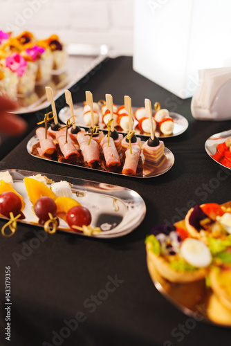 Obraz na płótnie Assorted canapes on metal trays. Delicious appetizers for a buffet. w salonie