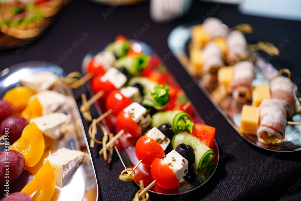 Assorted canapes on metal trays. Delicious appetizers for a buffet.