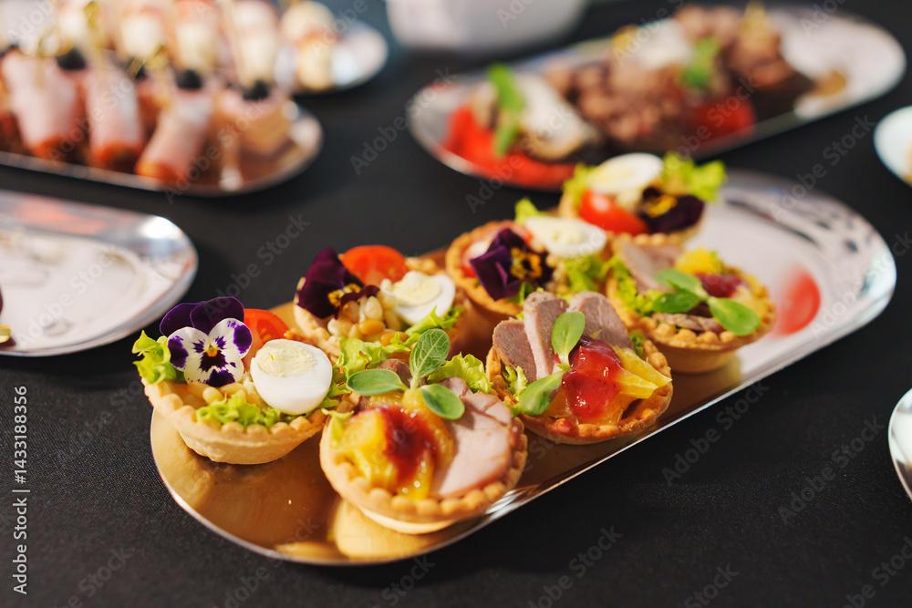 tartlets with pate and salad garnished with flowers. Delicious appetizers.