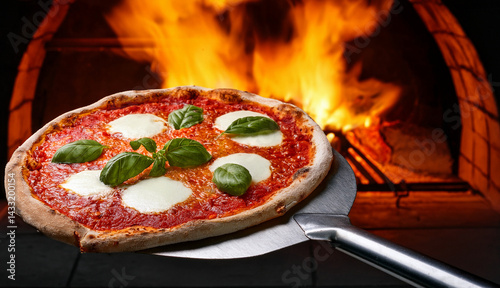 Italian pizza in front of the pizza oven