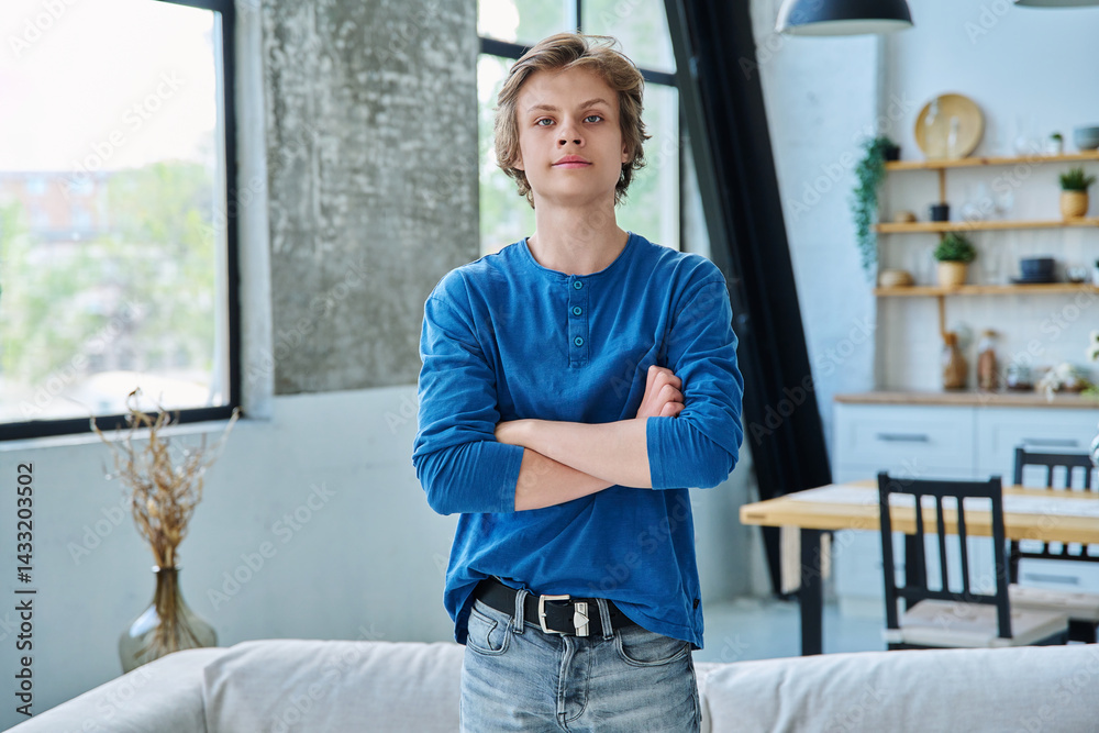 Fototapeta premium Portrait of confident handsome teenage boy with crossed arms