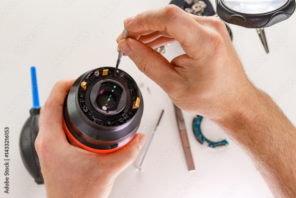 the hands of the master and a broken lens of a professional camera.