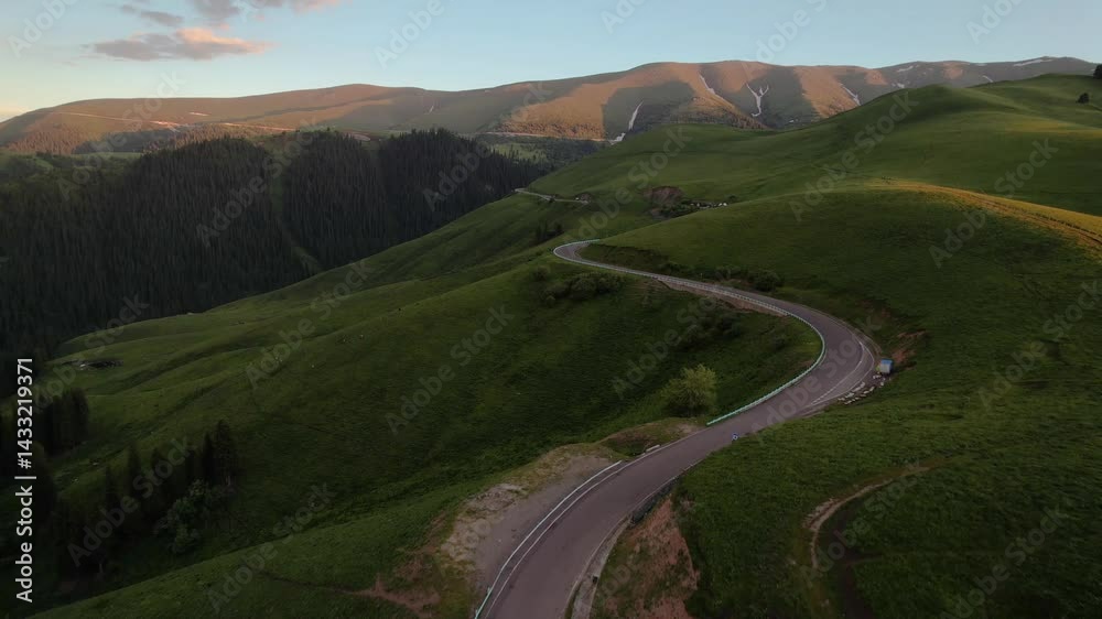 Aerial view of Dokugu Highway winding through hills at sunset's golden hour Aerial view of Dokugu Highway winding through hills at sunset's golden hour