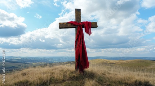 Christian cross stands tall, red cloth draped over, symbolizing faith hope, amidst nature's backdrop.