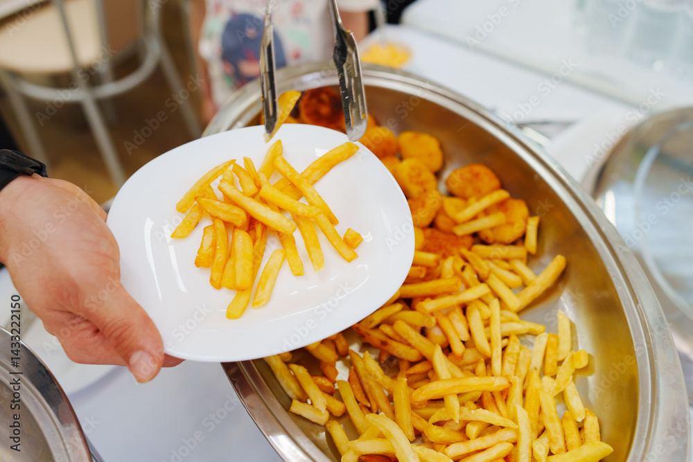 Heated tray with french fries and nuggets. Banquet food delivery.