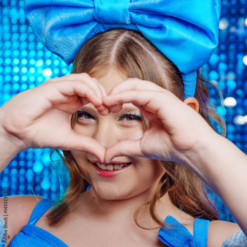 close up. Cute teenage girl in blue doll dress with big blue bow posing.