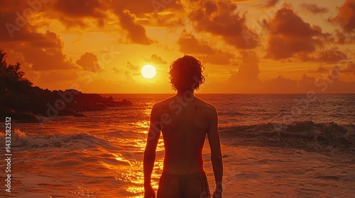 Man Silhouetted Against a Vibrant Sunset Over Ocean