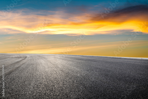 Fototapeta Naklejka Na Ścianę i Meble -  Asphalt road and beautiful sky clouds at sunset