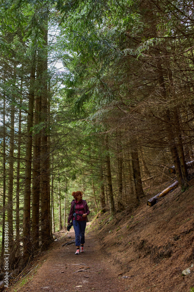 Woman hiking on forest trail