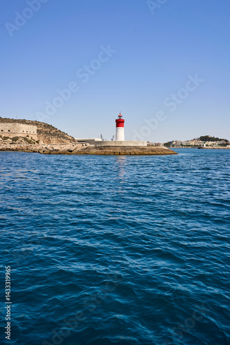 Red or white lighthouse in the blue sea
