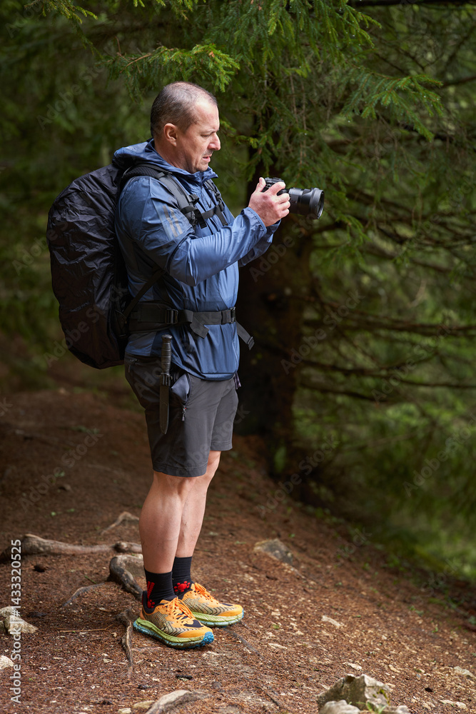 Man photographing forest trail with camera