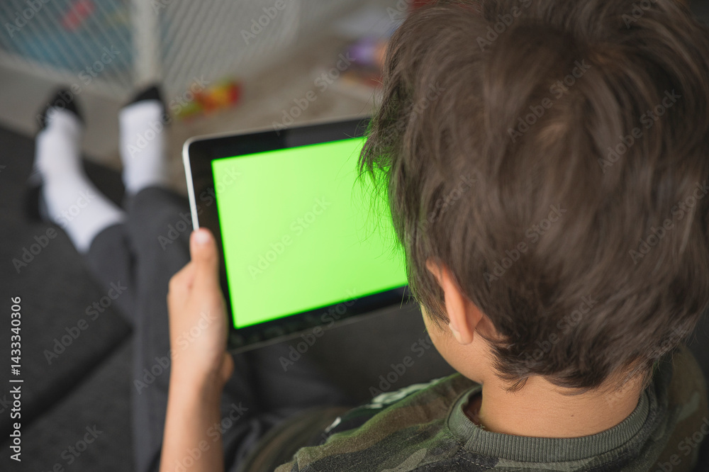 Boy using social media on tablet with chroma key background. touchscreen device for social networks browsing Boy using social media on tablet with chroma key background. touchscreen device for social networks browsing