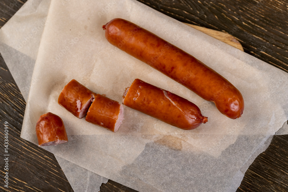 pork sausage fried in oil, sausages on food paper,top view