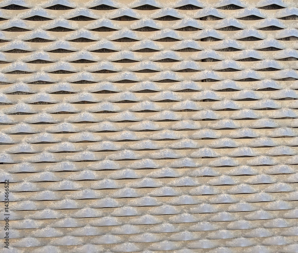 Textura metálica abstracta con patrón perforado con figura de diamantes Textura metálica abstracta con patrón perforado con figura de diamantes