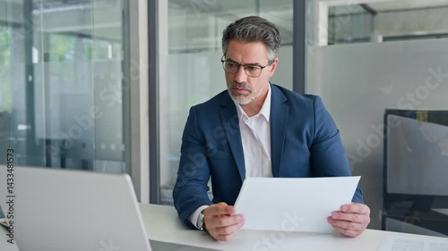 Busy financial specialist senior man working with finance sales document report and pc laptop computer in office. Mature executive businessman professional doing analysing paperwork, business review 