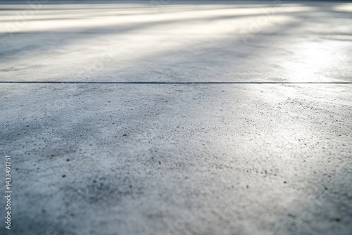 Outdoor concrete floor with sunlit shadows. photo