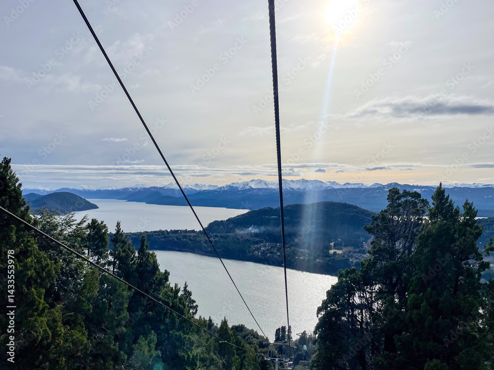 Beautiful range of snowy mountains and a lake with blue sky above in Bariloche Argentina, amazing panoramic view at Circuito Chico Patagonia.