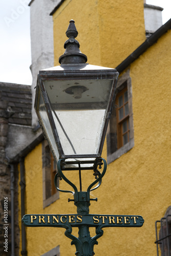 Fototapeta Naklejka Na Ścianę i Meble -  Street light and street name on a small city road in Edinburgh, the capital of Scotland.