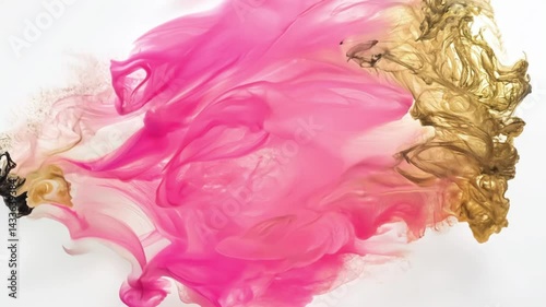 Abstract pink and gold ink mixing in liquid. Vibrant magenta and metallic golden colors blend together in water, creating flowing organic patterns that gradually spread and merge.