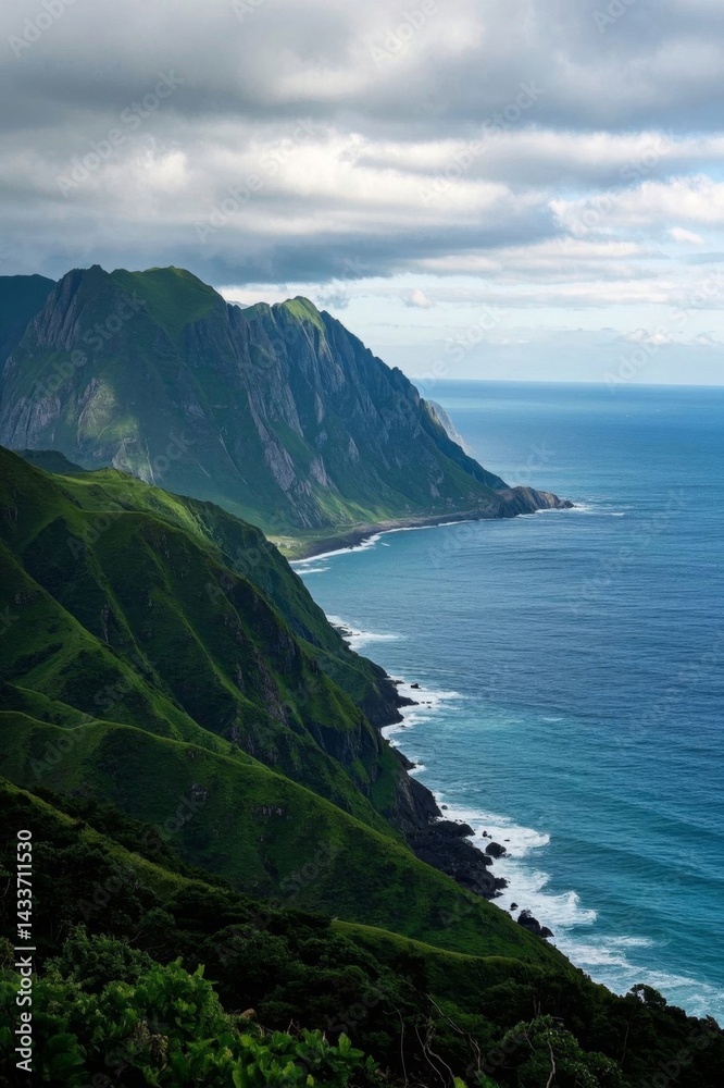 Fototapeta premium mountains and ocean with a few clouds in the sky