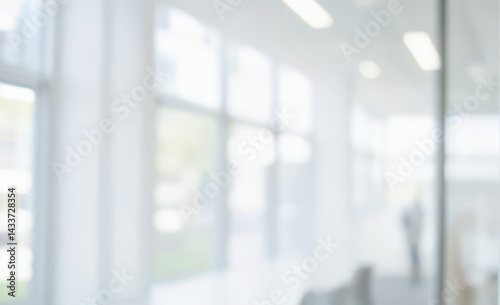 Blurred image of bright interior space with large windows and white walls. Ultra bokeh photo without focus with a soft and warm touch of light.