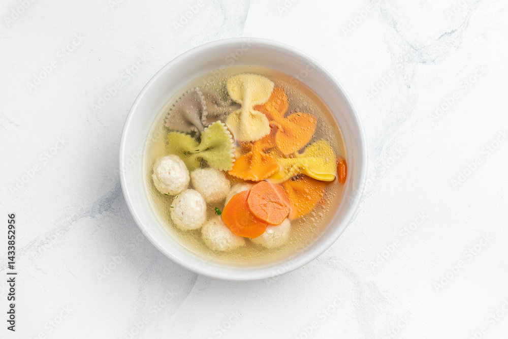 Chicken soup with noodles and vegetables in a bowl isolated on white background Chicken soup with noodles and vegetables in a bowl isolated on white background
