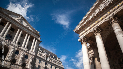 British Financial Institutions. A low, wide-angle view to the facade to the iconic Bank of England building and Royal Exchange in the heart of The City of London's financial district.