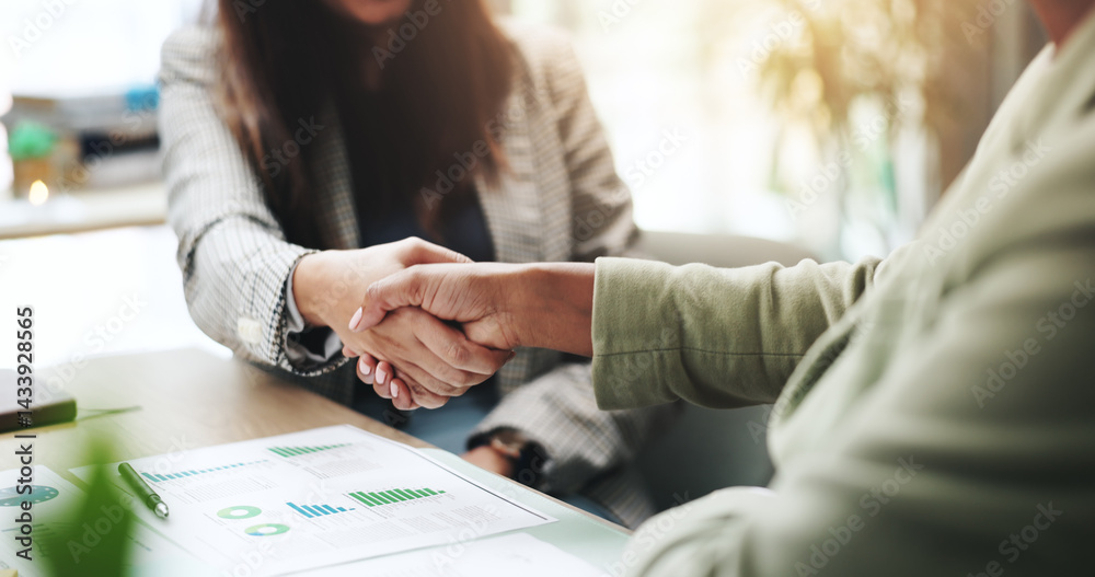Hands, business people and handshake with deal, graphs and profit growth or sales analytics. Closeup, thank you and financial advisor with agreement, B2B welcome or CRM with charts or company revenue