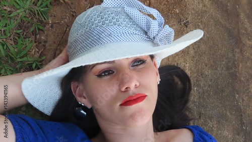 expressive look of a beautiful woman wearing a white hat