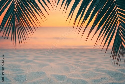 Fototapeta Naklejka Na Ścianę i Meble -  Tropical palm leaves framing sandy beach at sunset