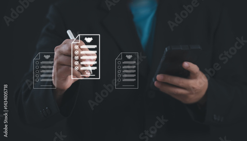 Digital contract agreement and business approval concept. Businessman selects documents with check marks and handshake icon on virtual screen to represent successful online transaction.	
