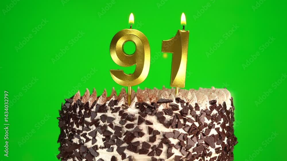 Burning candles number 91 on birthday cake against chroma key background. Ninety-first birthday. Birthday and anniversary celebration
