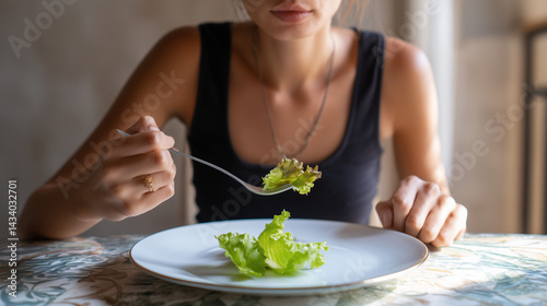 Woman Eating Lettuce with Fork