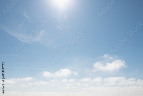 Obraz na płótnie Blue sky with white clouds and sun with sunbeams at sunny day. Abstract nature background. w salonie