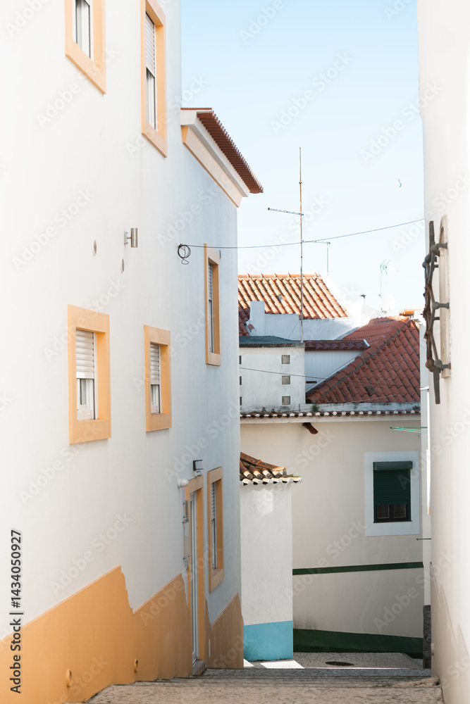 Cozy street at sunny day in Nazare, Portugal. Traditional portuguese architecture on the coast of Atlantic ocean