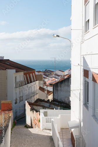 Obraz na płótnie Traditional architecture on the coast of Atlantic ocean in Nazare, Portugal. View of the beach and ocean in the background w salonie