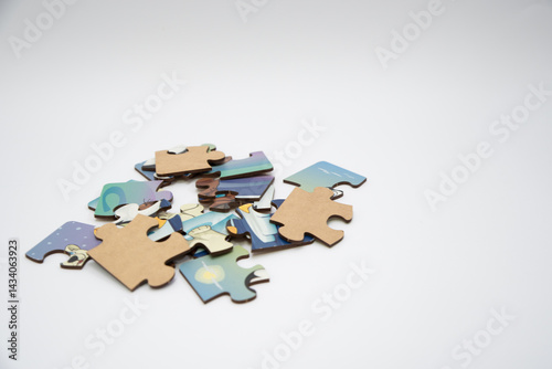 Fototapeta Naklejka Na Ścianę i Meble -  Puzzle pieces in a pile on a white background. Close-up