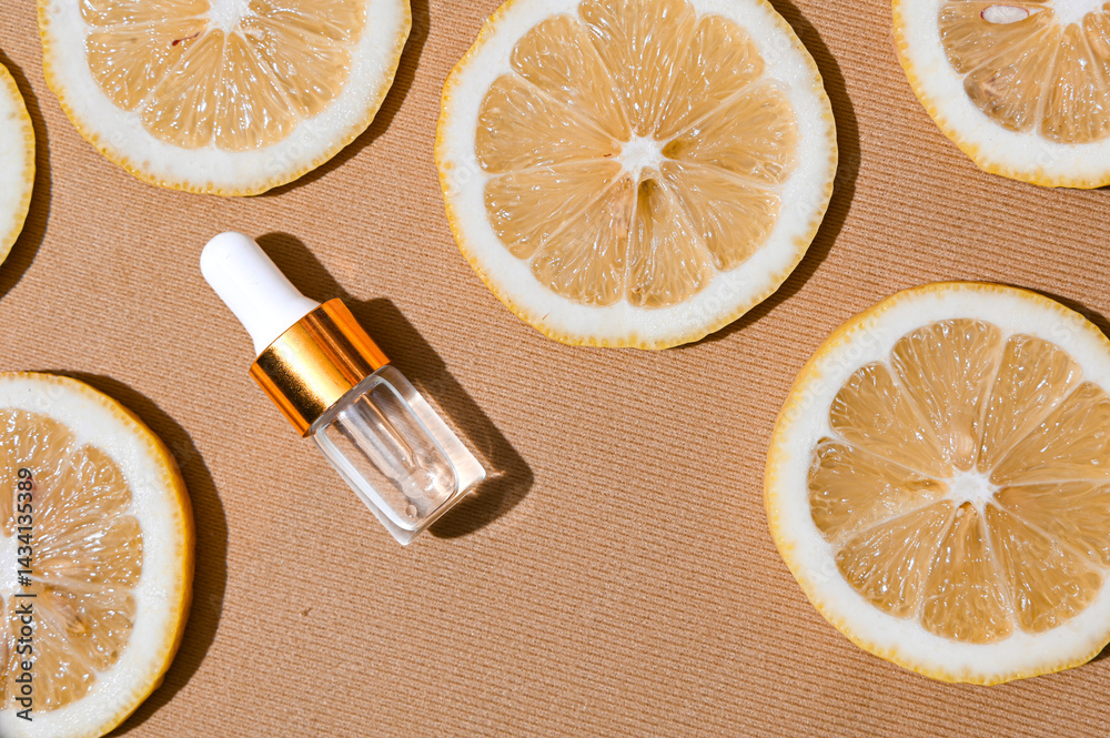 Two transparent serum dropper bottles with golden caps placed on textured beige background, surrounded by fresh lemon slices. Clean, elegant skincare flat lay for beauty and citrus-themed ads