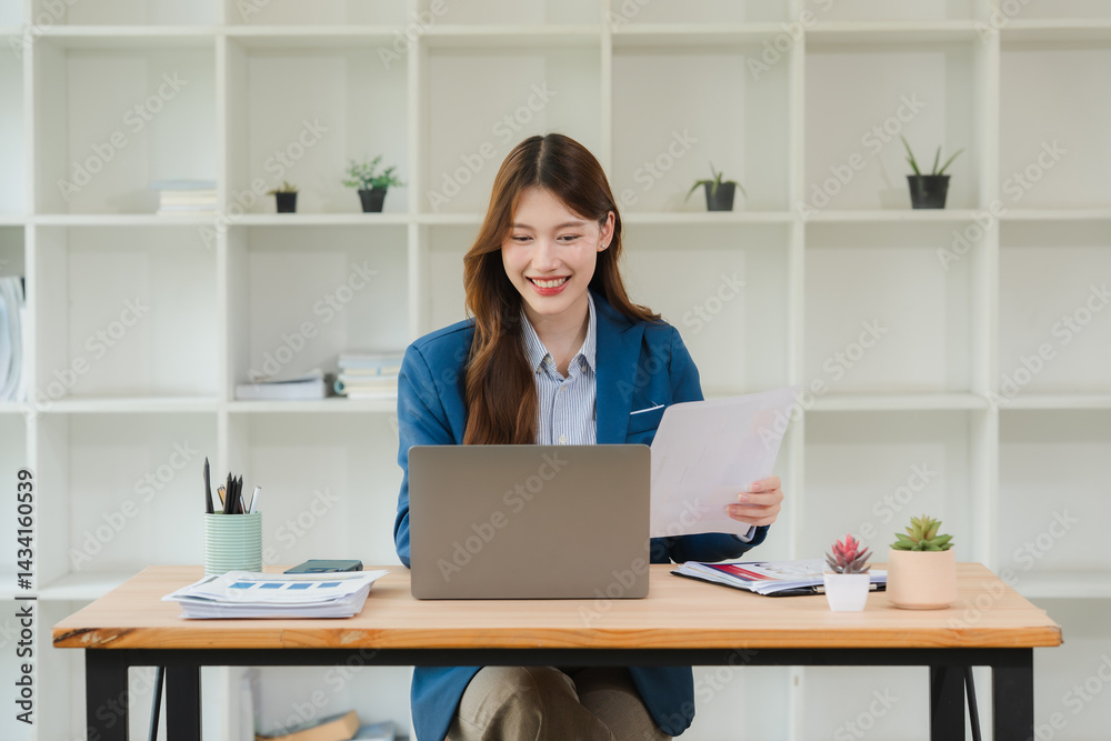 Smiling Asian Businesswoman Working at Desk Smiling Asian Businesswoman Working at Desk