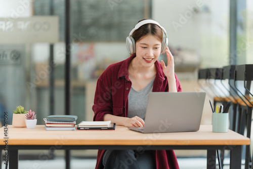 Young Woman Working on Laptop with Headphones