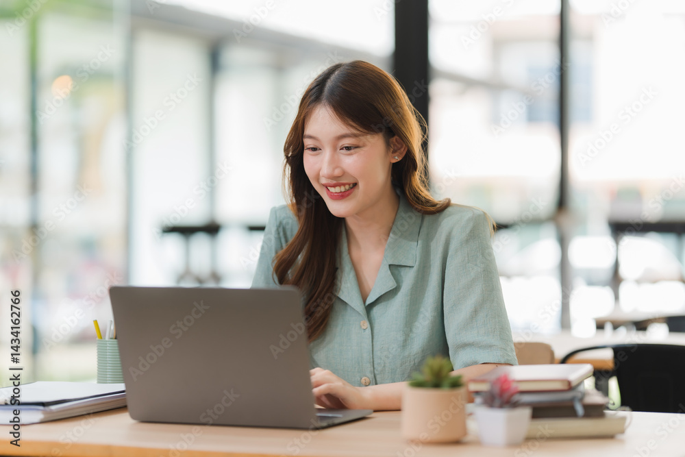 Smiling Asian Woman Working on Laptop Smiling Asian Woman Working on Laptop