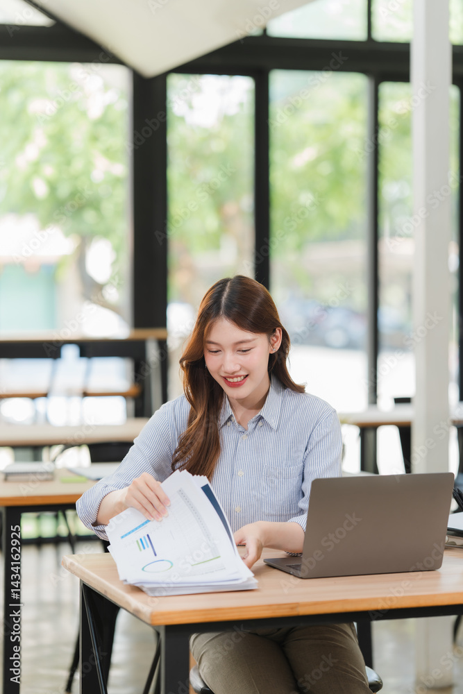 Smiling Asian Woman Working with Documents and Laptop Smiling Asian Woman Working with Documents and Laptop
